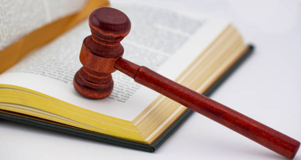 Book and ribbon marker with polished wood gavel stock photo