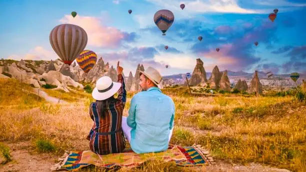 Photo of Cappadocia Turkey during sunrise, couple on vacation in the hills of Goreme Capadocia Turkey