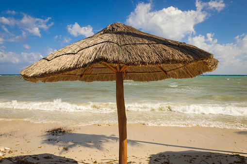 A palapa in Mexico stands in the mid day sun
