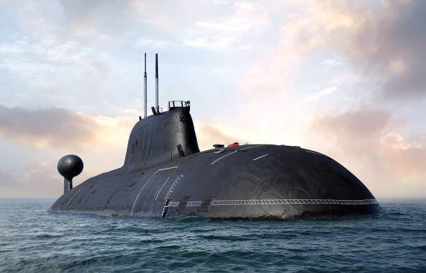 istock Naval submarine on open sea surface with cloudy sky 1469875667