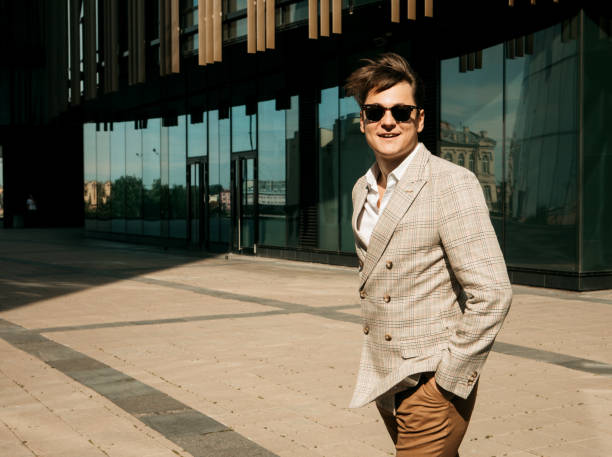 istock Handsome young businessman while walking outdoors with office building in the background. 1469881768
