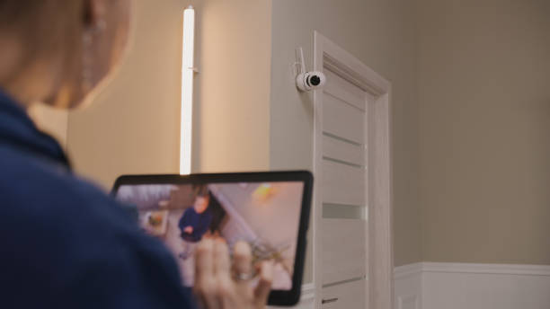 istock Woman checks security cam after installation 1469886878