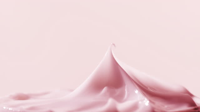 Macro turntable shot of pink cosmetic cream jar has been opened