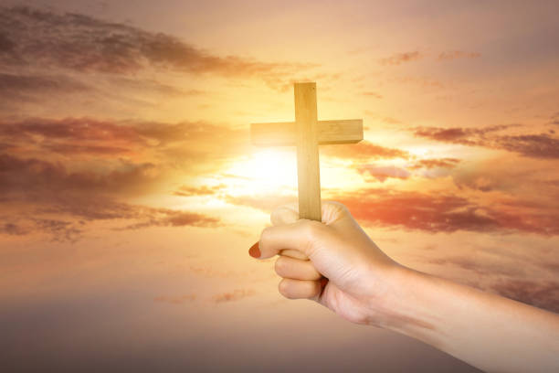 istock Human hand holding Christian cross 1469887052