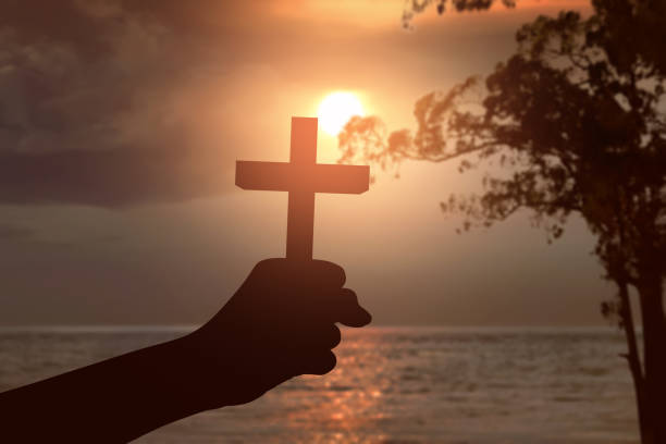 istock Human hand holding Christian cross 1469887061