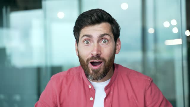 portrait of surprised businessman looking at camera computer monitor screen. surprised by the good news wow emotion shocked shoots