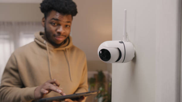 istock African American man sets up security camera 1469888310