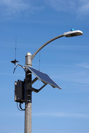 High tech street light with solar panel and a communication unit with antennas
