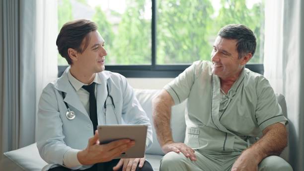istock Young doctor using digital tablet explain the symptoms to the patient after treatment or Talking With old man patient in the hospital 1469892298