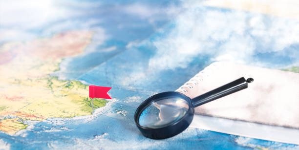 istock A magnifying glass with pins pinned on the map. Travel plan concept. 1469893290