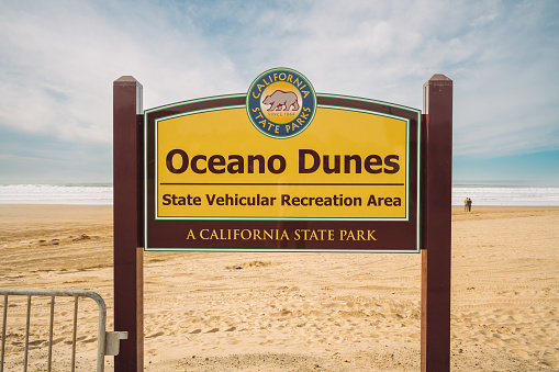 Oceano, California, USA - January 12, 2022. Oceano Dunes State Vehicular Recreation Area, a California State Park sign. Beach access