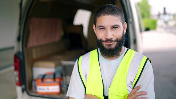 istock A man EMS Professional paramedic looking at camera standing and cross arms in Front of Ambulance Vehicle 1469893530