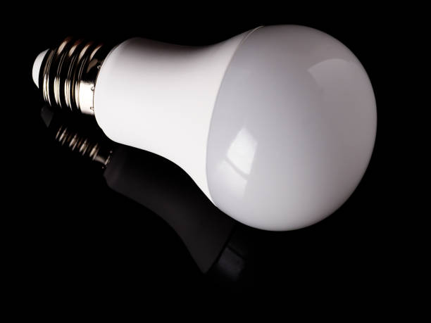 istock Energy saving LED light bulb isolated on a black background 1469894204