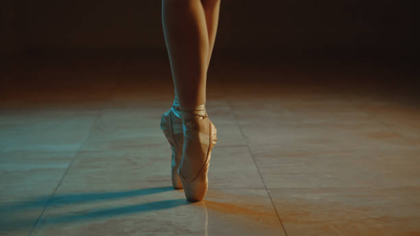 istock Close up ballet dancer feet in pointe shoes 1469894252