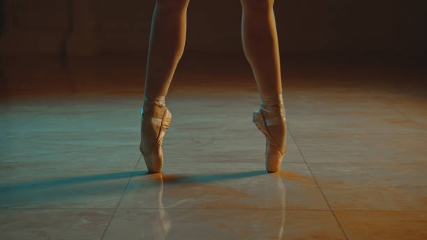 istock Close up graceful ballet dancer feet in pointe shoes 1469894324