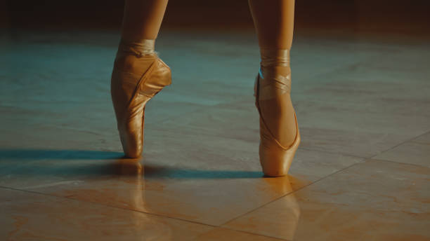 istock Close up graceful ballet dancer feet in pointe shoes 1469894360