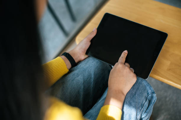 istock Hands of young woman using digital tablet in cafe 1469895873