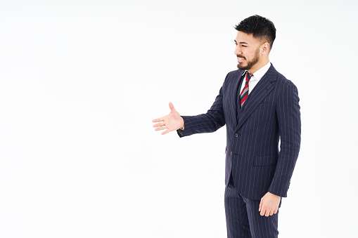 A man in a suit asking for a handshake and white background