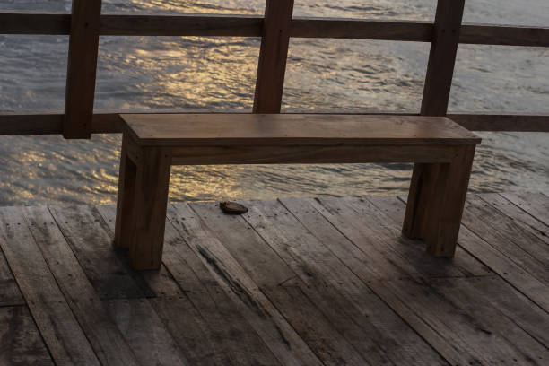 chair made by wooden on sides of fence in beach