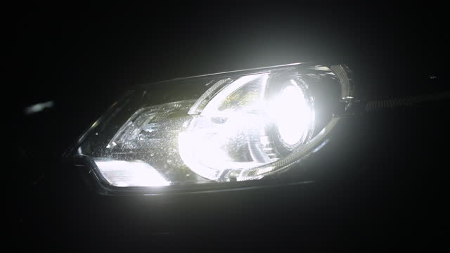 Close up pan around of bright car headlight