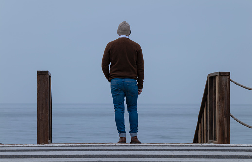 Rear view of adult man against sea