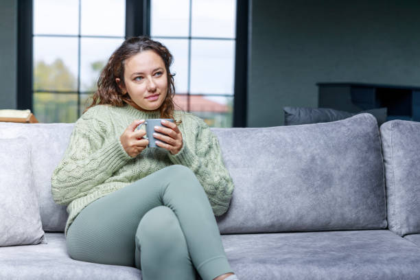 istock Young woman drinking a cup of coffee 1469903755
