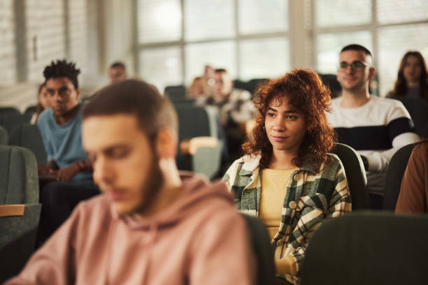 istock College students attending a class in amphitheater. 1469904237