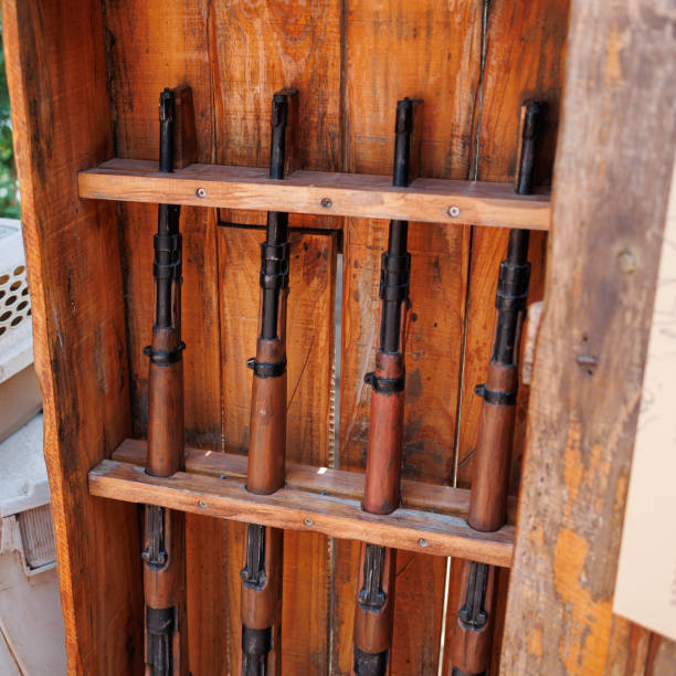 istock Four Guns placed inside their Wooden Shelf 1469906543