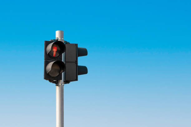 istock Red pedestrian light in front of a cloudless blue sky 1469906572