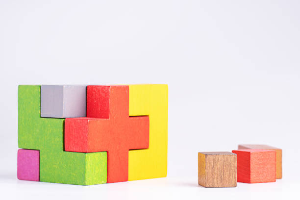 istock Colorful wooden cube puzzle on the white table. Concept of decision making process, logical thinking. Geometric shapes on a white background. 1469907025