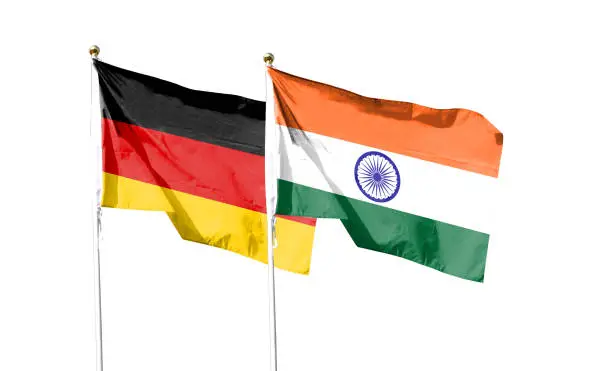 Photo of German flag with Indian flag on cloudy sky. waving in the sky