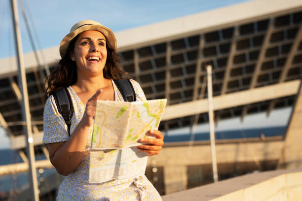 istock Happy young woman with a city map travelling. 1469909784