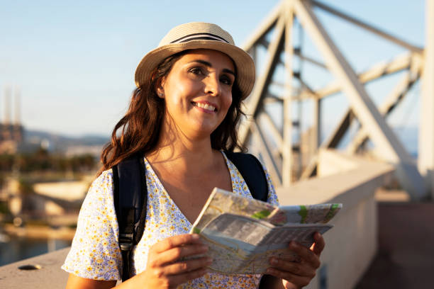 istock Happy young woman with a city map travelling. 1469909799