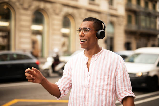 istock Handsome African man listening music outside 1469910544