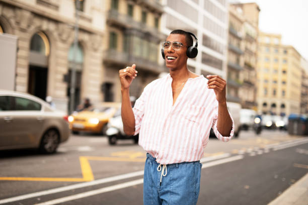 istock Handsome African man listening music outside 1469910569