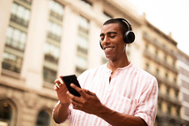 istock Handsome African man listening music outside 1469910595