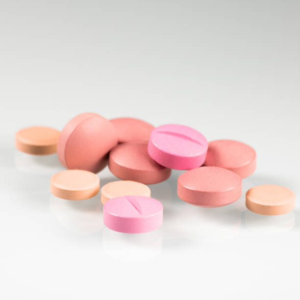istock Pink pills, medicine isolated on white background, top view 1469911900