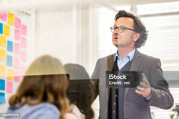 Business Coach Training Corporate Workers In Conference Room Stock Photo - Download Image Now