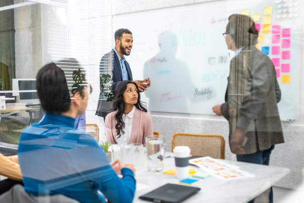 istock Corporate employees using kanban project planning technique in conference room 1469911996