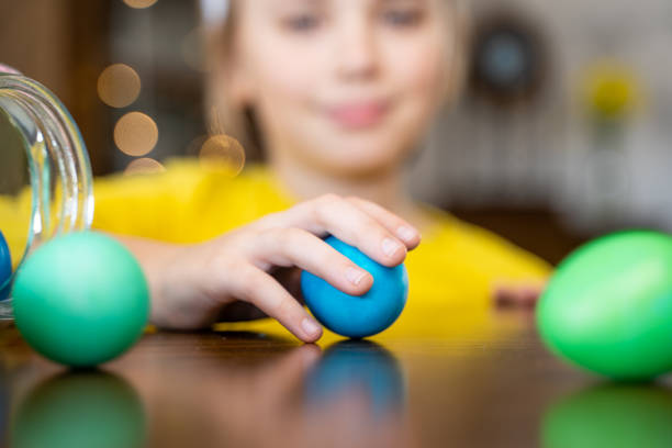 istock Easter Family traditions. Close-up caucasian child hands playing with decorated multi-colored eggs. Kid having fun. Negative copy space 1469912619