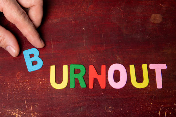 istock BURNOUT. Colorful text from alphabet letters on wooden background 1469913504