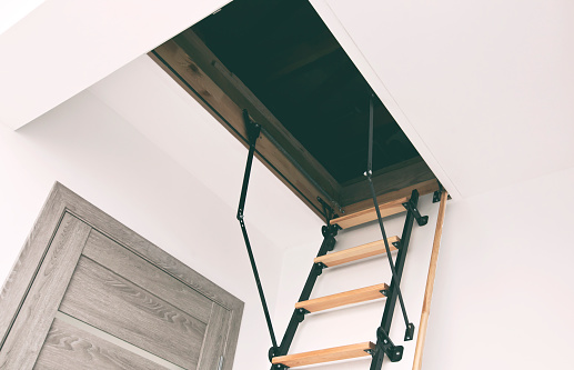 Wooden staircase to the attic in the house