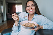 Pregnant woman enjoying a bowl of cereals.