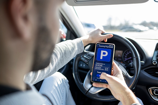 Driver using smartphone app to pay for parking