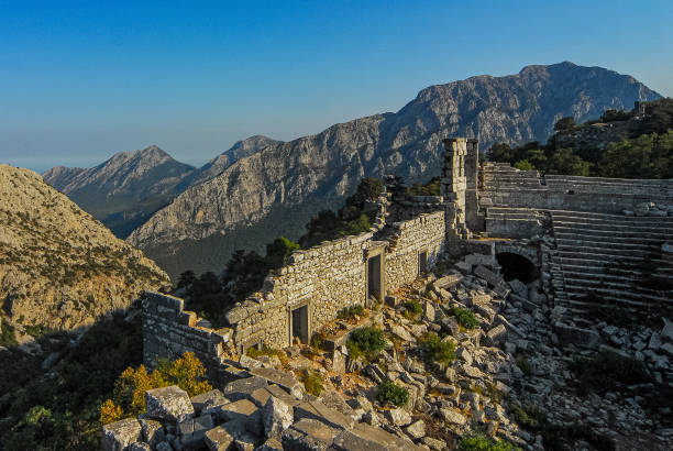 Theater in the ancient city of Termessos. Taurus mountains in the background Termessos, a mountain city, was founded by the Solymos (Solymites), known as a people fond of freedom. The Solymos mentioned in Homer's Iliad are known as the people of Termessos. The city of Termessos is one of the Psidia settlements in the Pamphylia region, established on the rocky slopes of Güllük Mountain. During the reign of Theodosius II in the 5th centuries AD, the location of the city was changed due to thirst.
This ancient city is located in the Güllük Mountain Termessos Historical National Park. termessos stock pictures, royalty-free photos & images