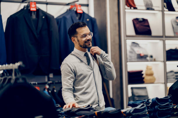 istock A young happy smart causal man is choosing clothes at store. 1469917984