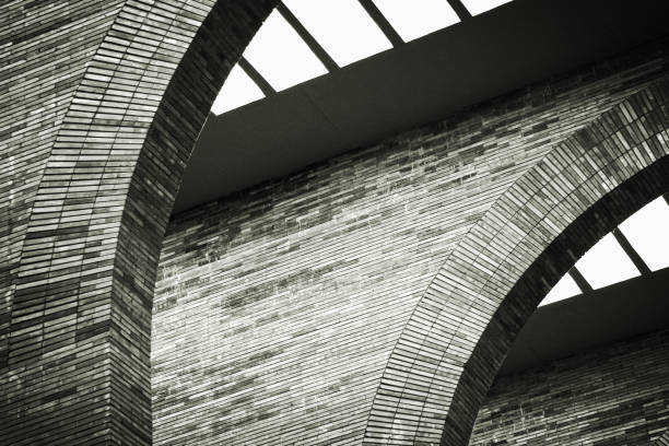 Abstract modern architecture, brick arches and walls, with skylights, curve, black and white