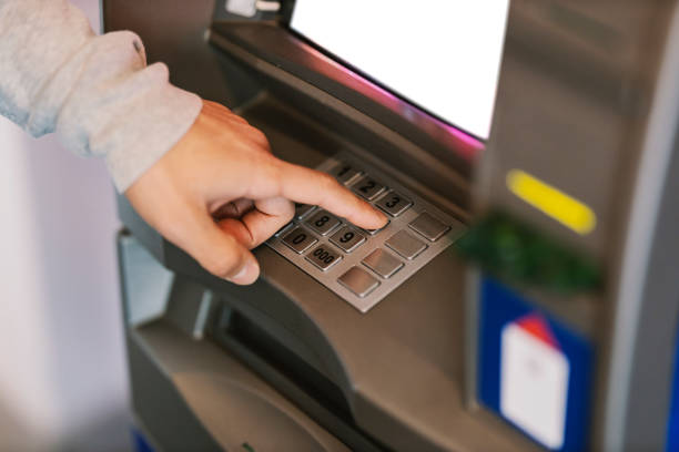 istock Close up of a hand typing PIN on ATM. 1469918734