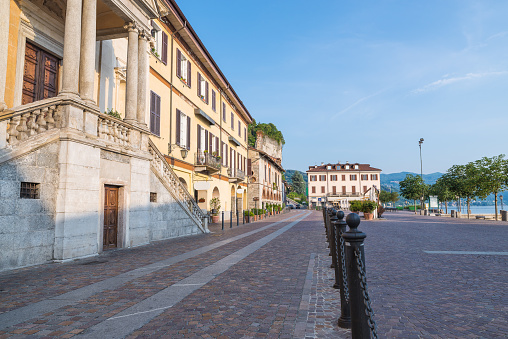 Picturesque view of the piazza del Popolo (square del Popolo) and of the oldest and most characteristic part of the town of Arona with typical restaurants, shops, the old port and the church of Santa Maria di Loreto (to the left). Province of Novara, Piedmont, northern Italy
