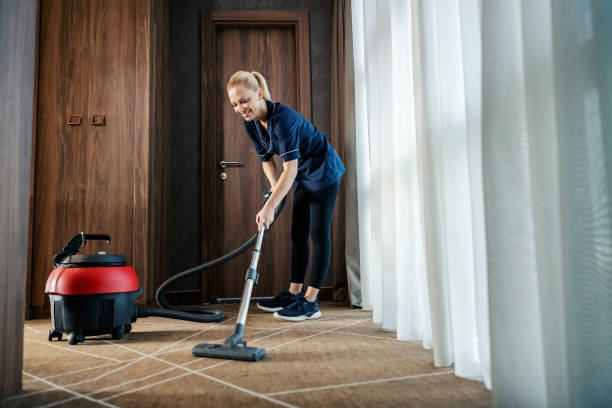 istock A chamber maid is using vacuum cleaner to cleanup hotel room. 1469918904